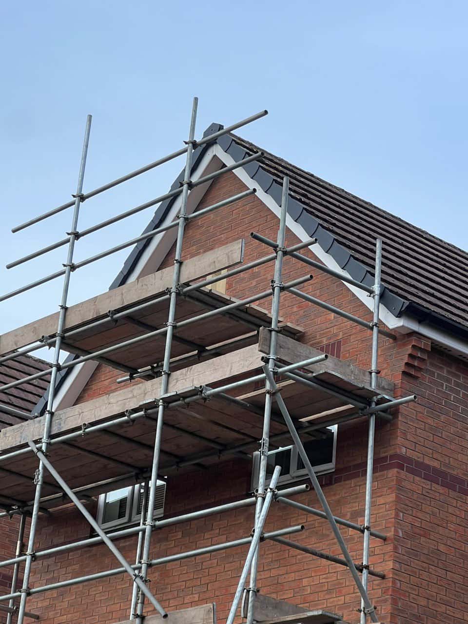 This is a photo of a roof which has just been repaired. There is a scaffold located at the gable end for access onto the roof. Works carried out by Fareham Roofing Repairs