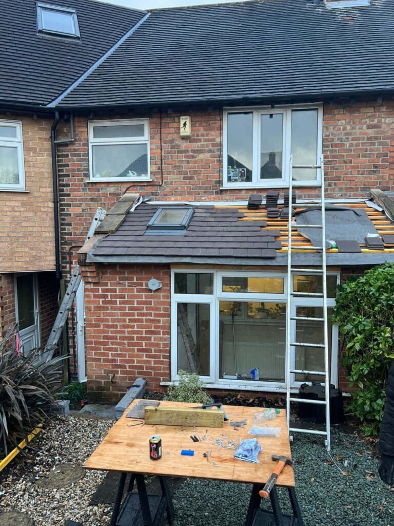 This is a photo of a roof extension that is having new roof tiles installed. This is a photo taken from the roof ridge looking down a tiled pitched roof on to a flat roof. Works carried out by Fareham Roofing Repairs